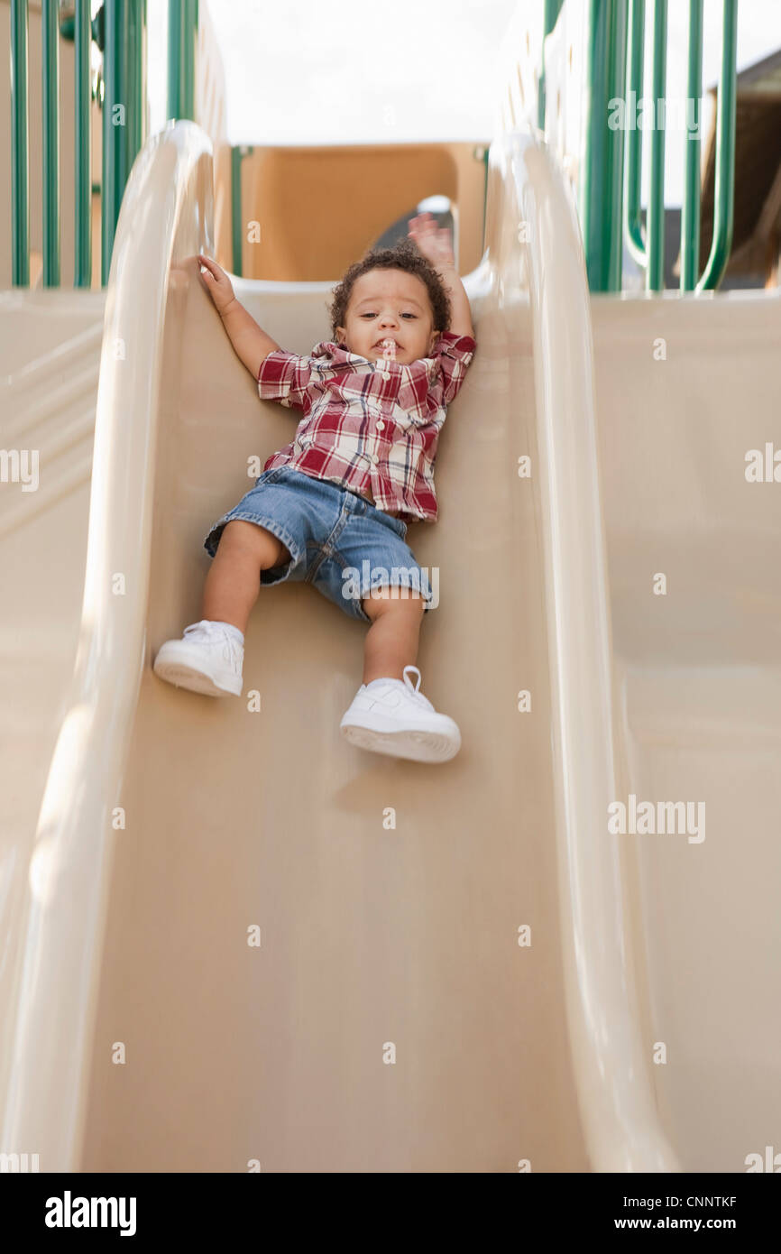 Young Boy Sliding Down Slide at Playground Stock Photo Alamy
