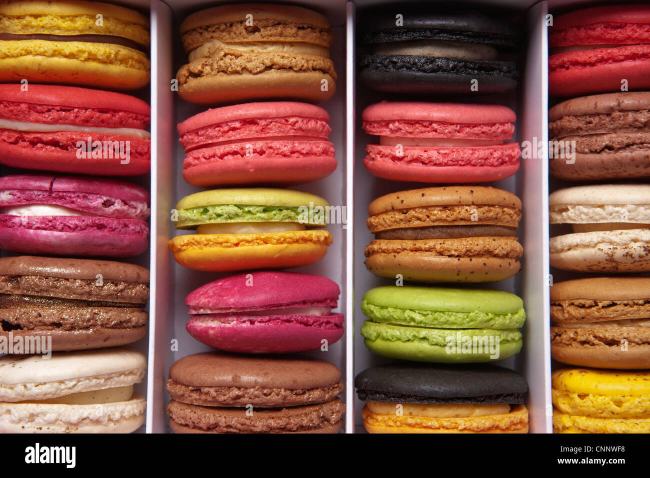 shot taken from above of a box full of macaron or French macaroon, colourful meringue-based almond treats Stock Photo