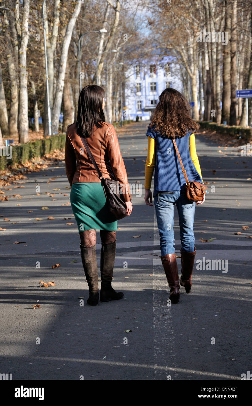 Two young women walking outdoors Stock Photo - Alamy