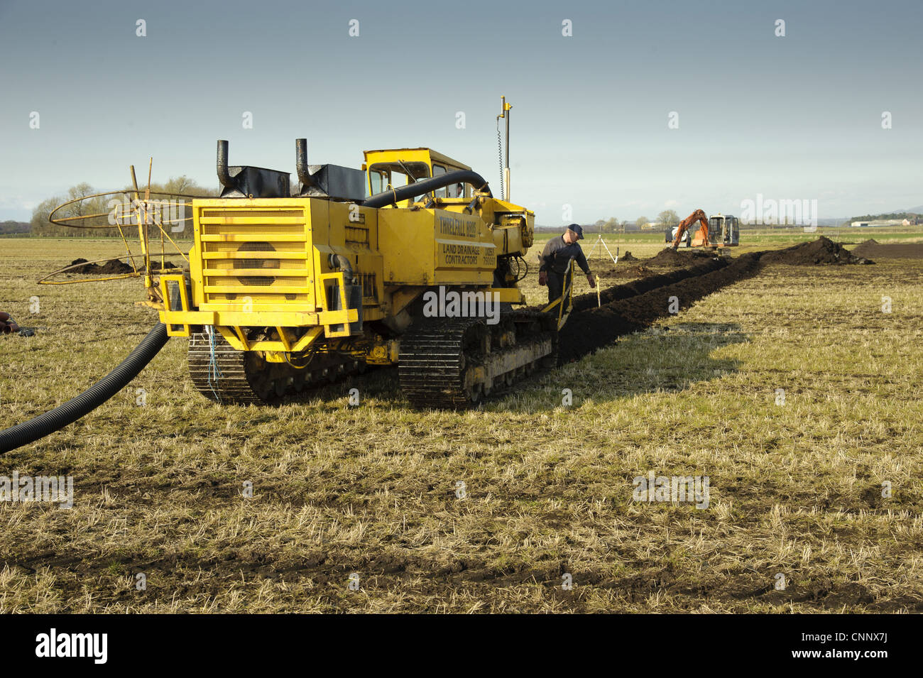 Field drainage, continuous pipe laying machine working in arable field
