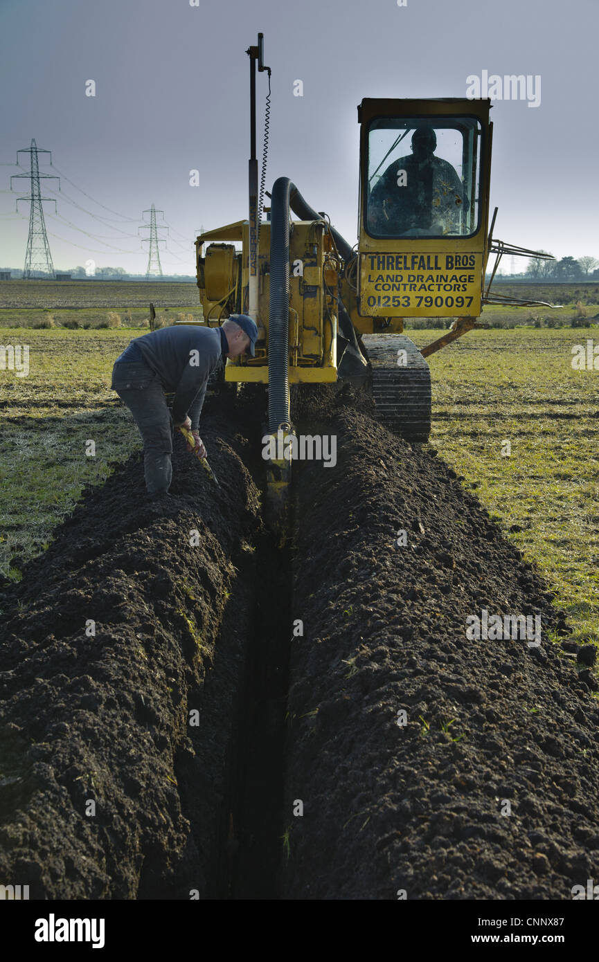 Field drainage, continuous pipe laying machine working in arable field, Pilling, Lancashire