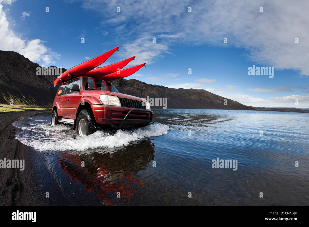 Jeep driving in shallow lake Stock Photo