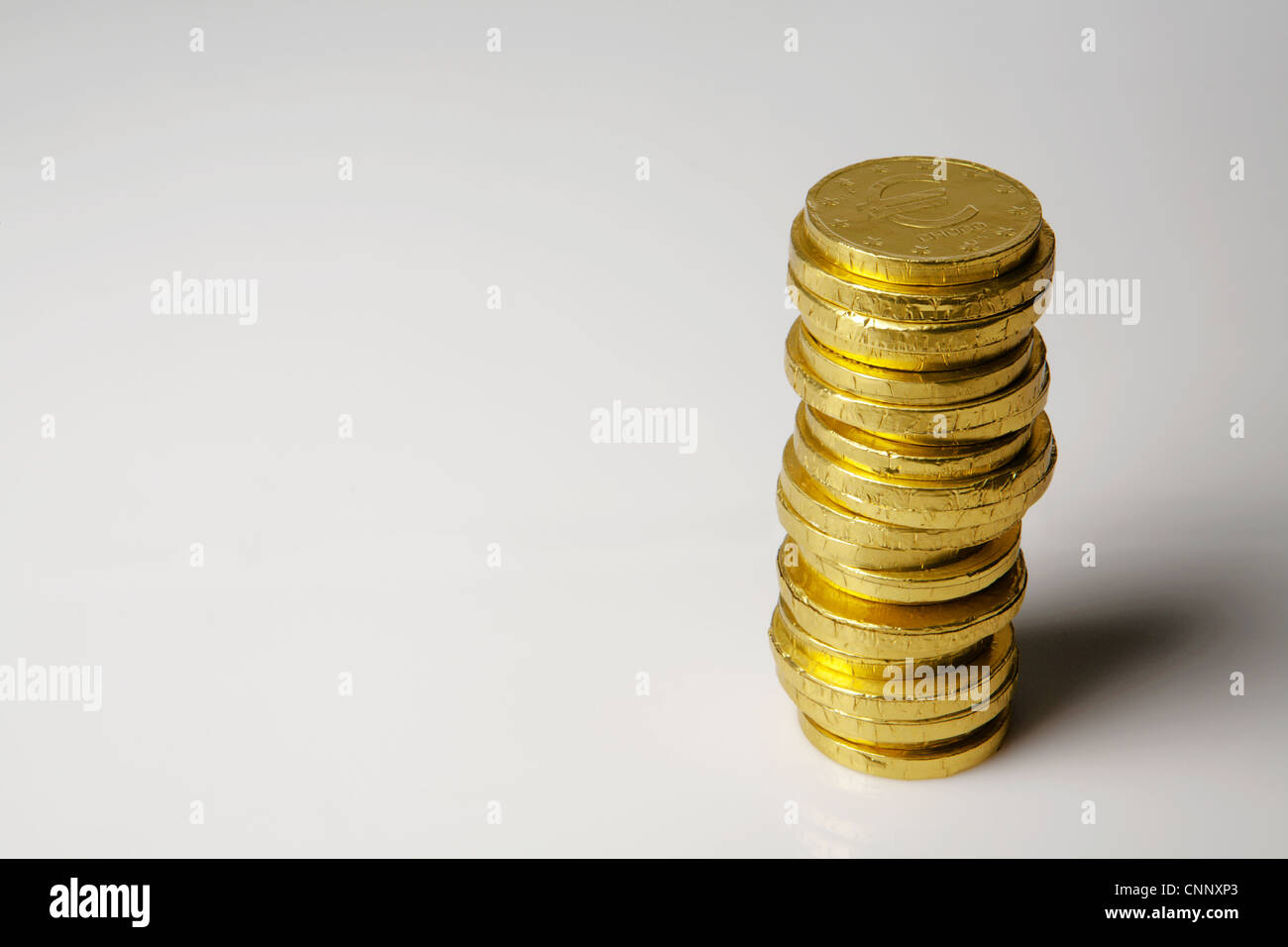 chocolate money coins on white background Stock Photo - Alamy