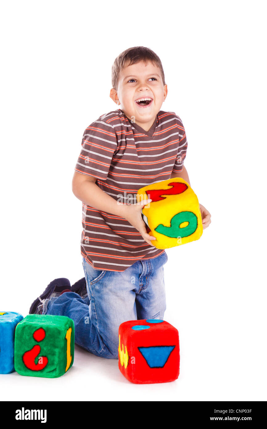 Happy kid throwing block with numbers over white background Stock Photo