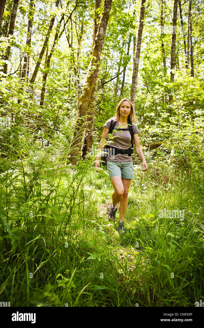 A woman hiking in the forest Stock Photo Alamy