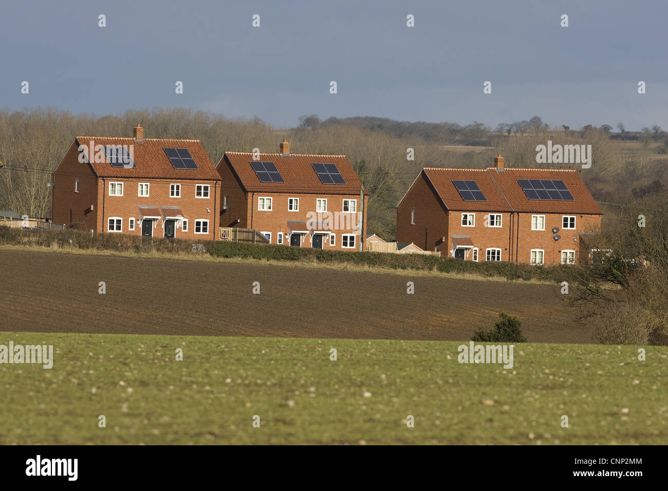 Houses with solar water heating panels on roof, Norfolk, England, march Stock Photo