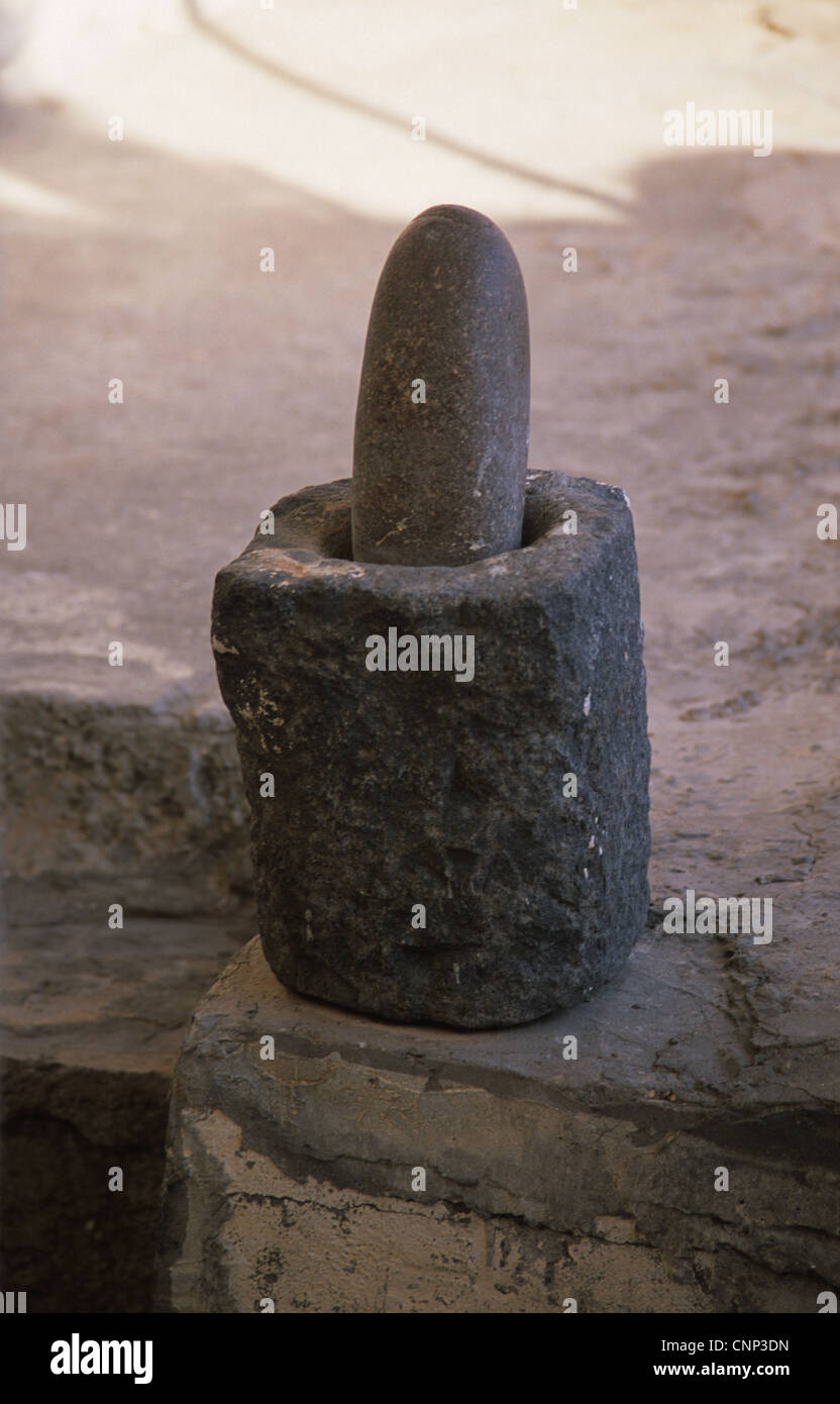 Ancient pestle and mortar or grindstone salvaged from floodwaters of