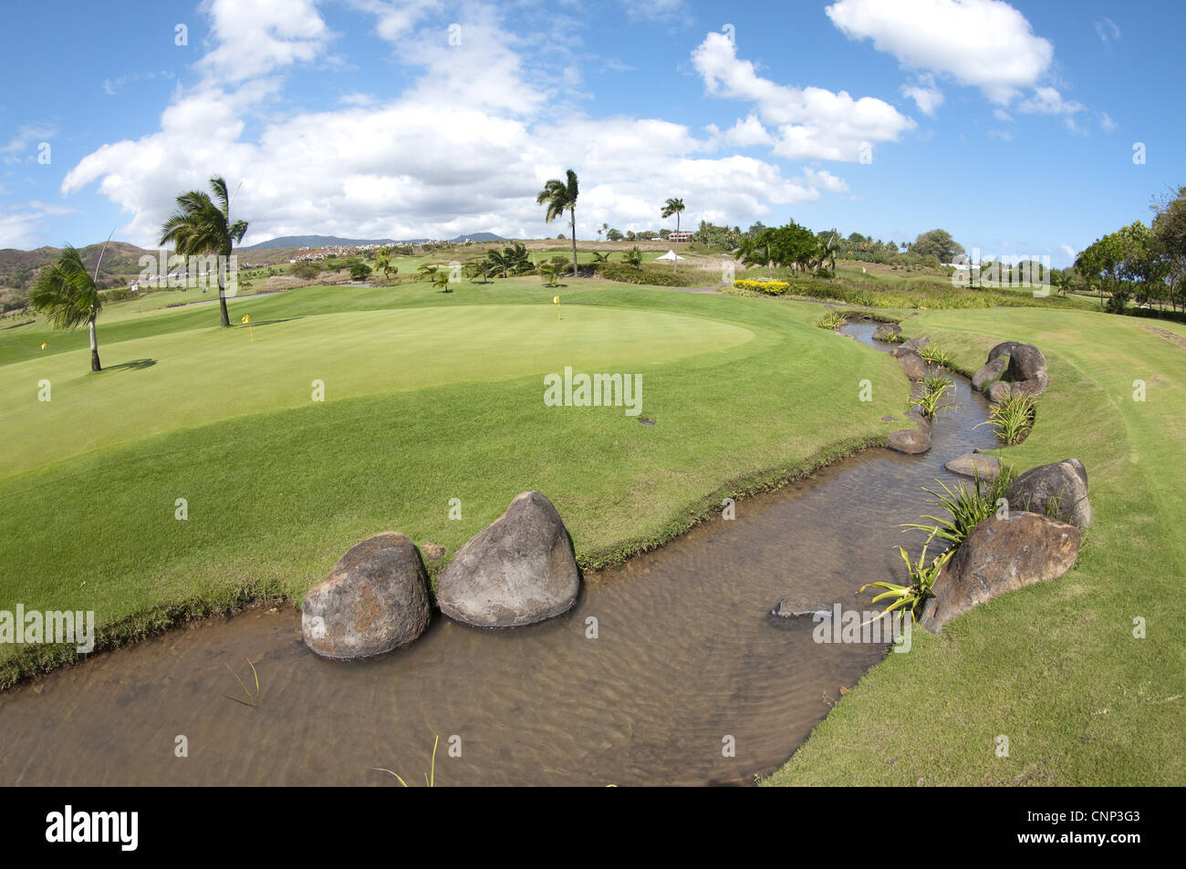 Stream running by practice green on golf course, Le Telfair Hotel and Golf Course, Bel Ombre, Southwest Mauritius Stock Photo