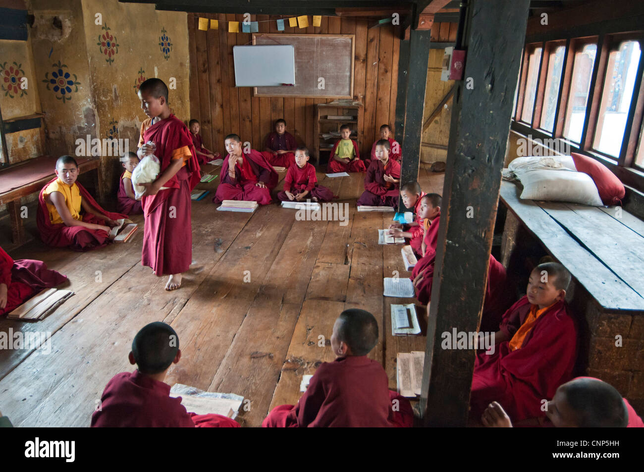 Asia, Bhutan. Young monks chanting in the Temple of the Divine Madman.  Credit as Stock Photo
