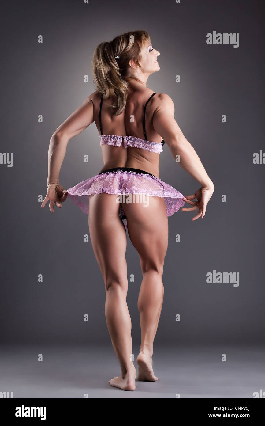 beauty female bodybuilder posing with sexy rose lingerie Stock Photo - Alamy