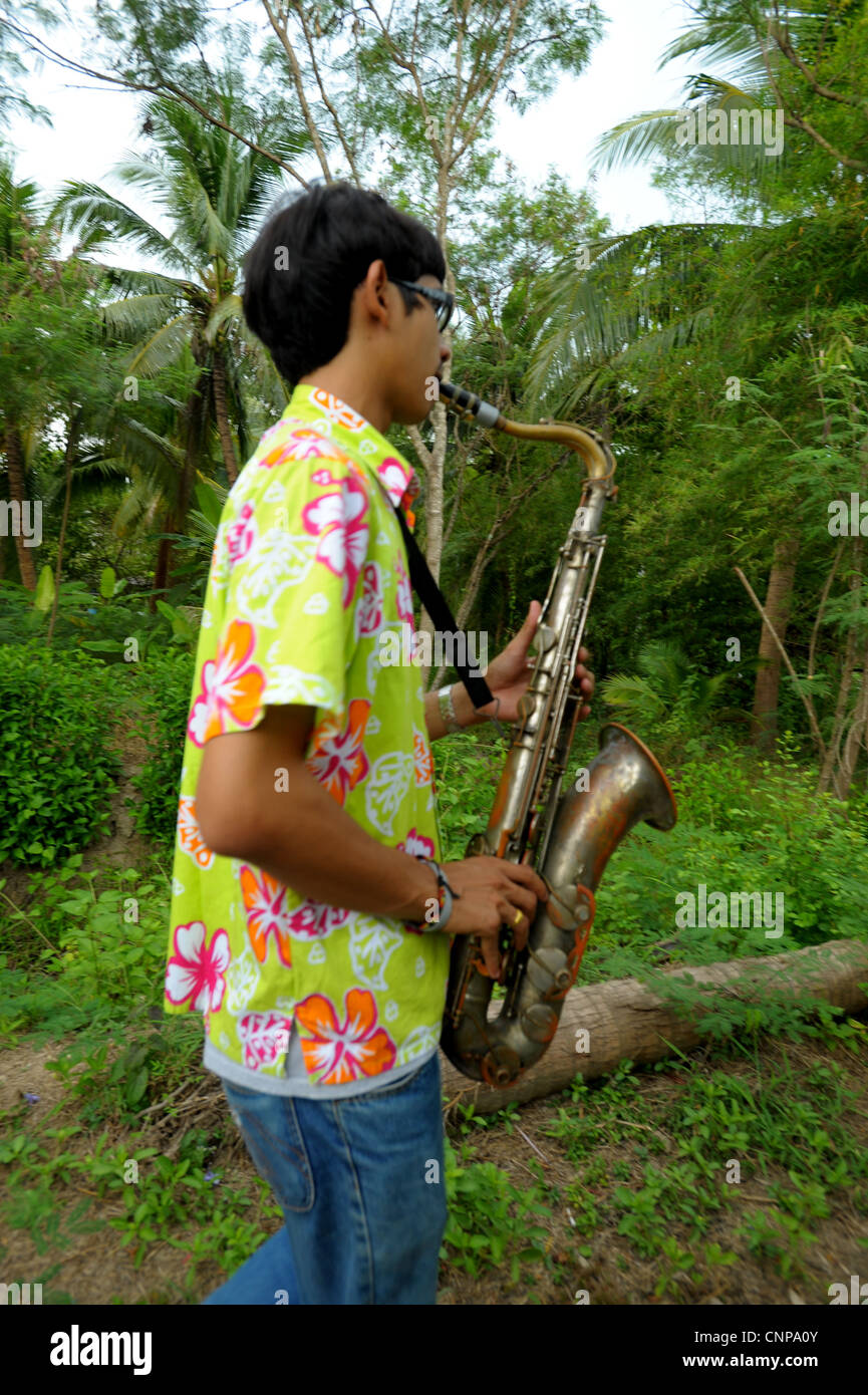 saxophone player during buddhist monk ordination ceremony,pong pang