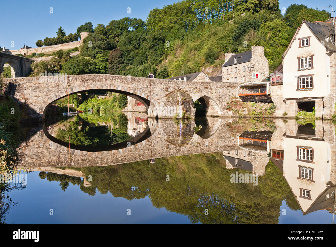 The old port of Dinan on the Rance River in Brittany, France with the main road bridge and city walls in the background. Stock Photo