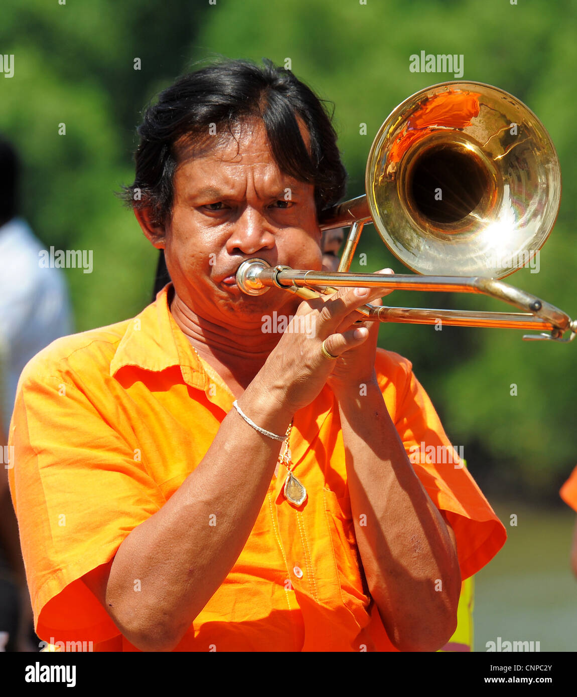 musician playing trombone , monk ordination ceremony ,wat pong pang