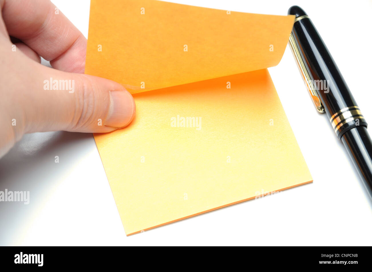 Tearing adhesive note Stock Photo