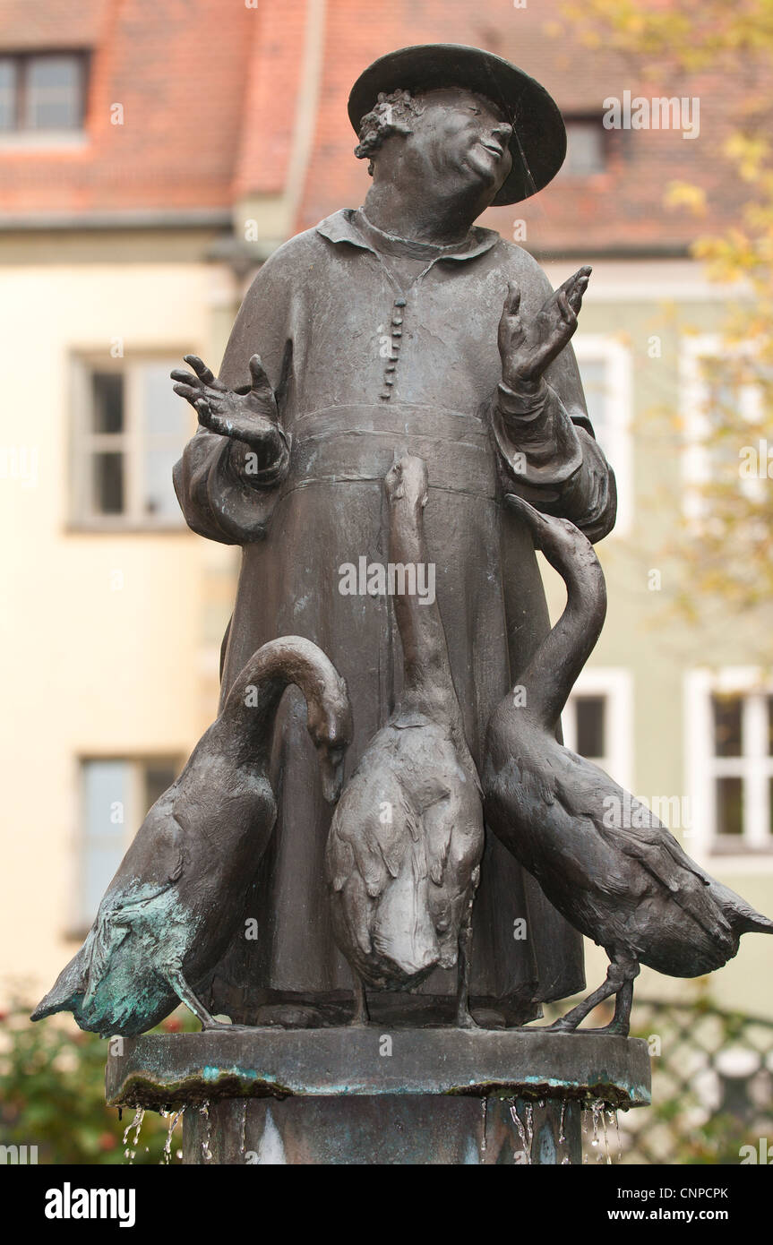 The Goose Sermon Fountain statue of the friar preaching to some geese at the Bischofshof hotel Regensburg, Germany. Stock Photo
