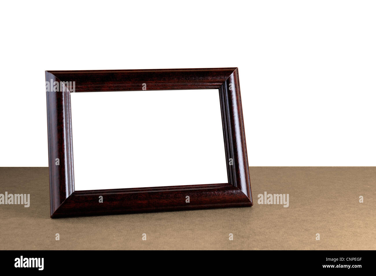 Old wooden photo frame on table isolated on white background Stock