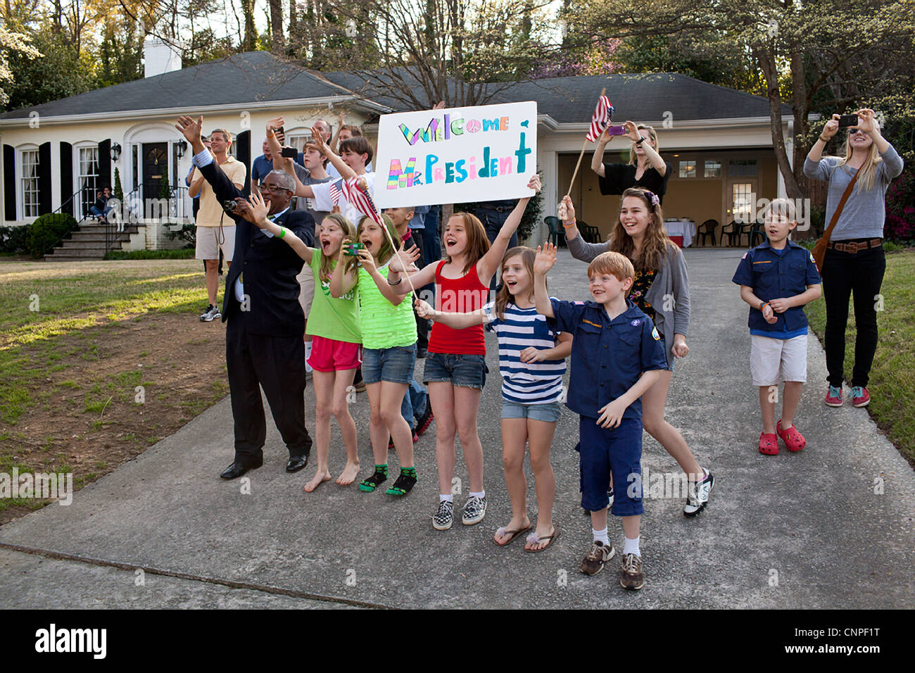 Supporters wave sign and cheer as US President Barack Obama visits to a neighborhood for an event March 16, 2012 in Atlanta, GA. Stock Photo