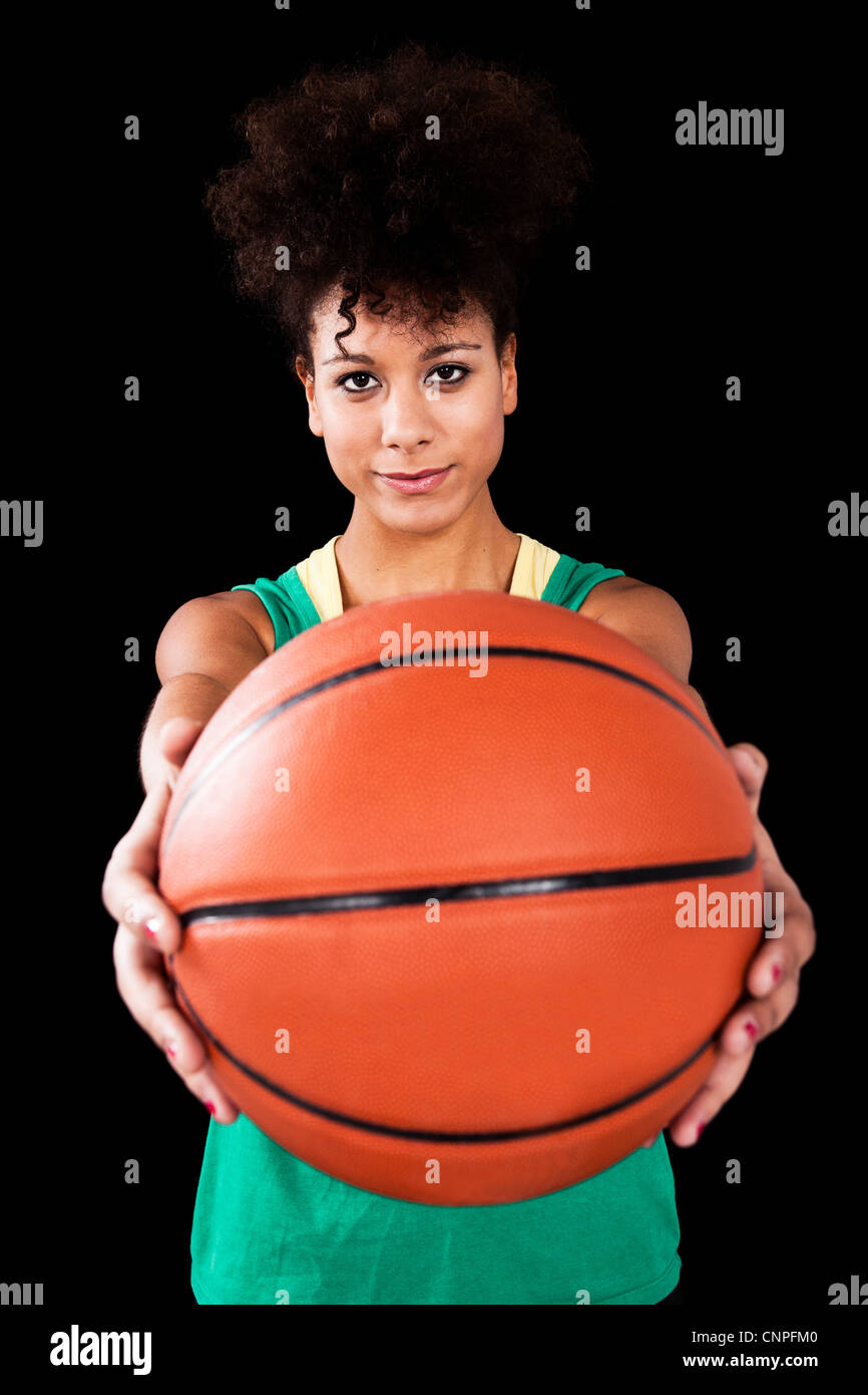 Athletic woman with a basketball. Studio shot with black background Stock Photo