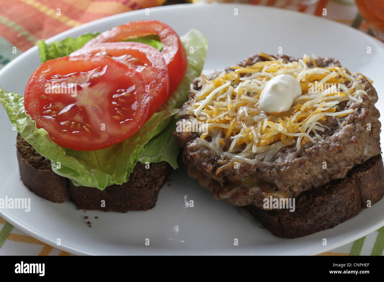 A double hamburger sandwich on pumpernickel bread Stock Photo Alamy