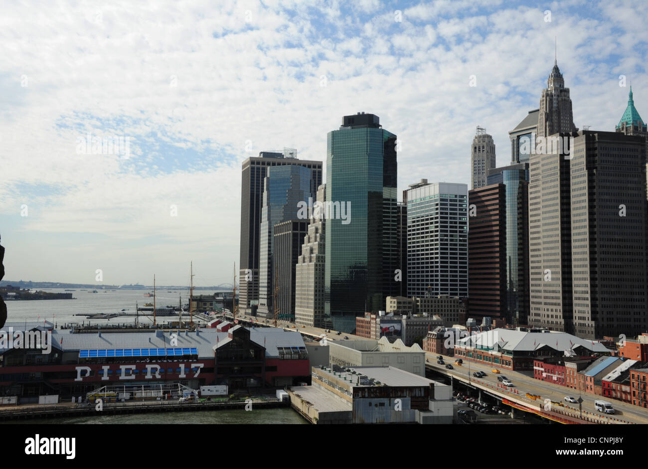 Autumn sky view, from Brooklyn Bridge, Pier 17 seaport, FDR Drive, Lower Manhattan Financial District skyscrapers, New York Stock Photo