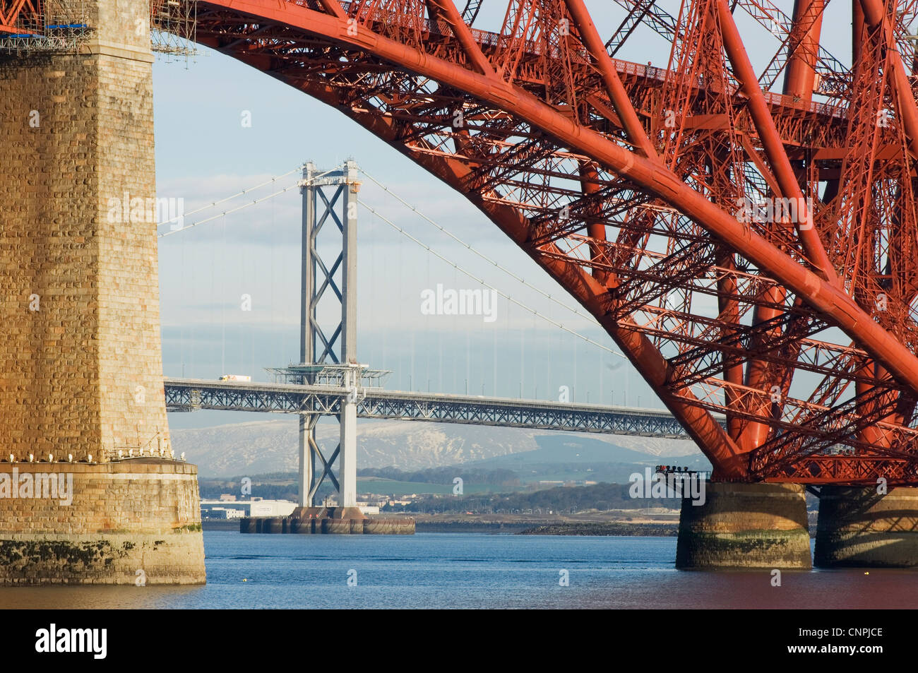 The Forth Road Bridge viewed through an arch of the Forth Rail Bridge, near Edinburgh, Scotland. Stock Photo