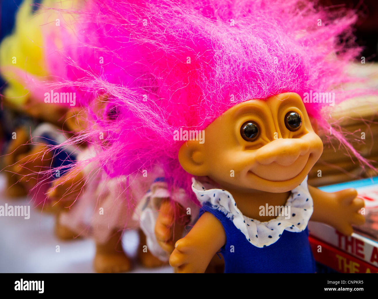 Colorful Troll dolls on sale in an antique market at Warrington. Trolls of this type were a popular fad during the 1960s Stock Photo