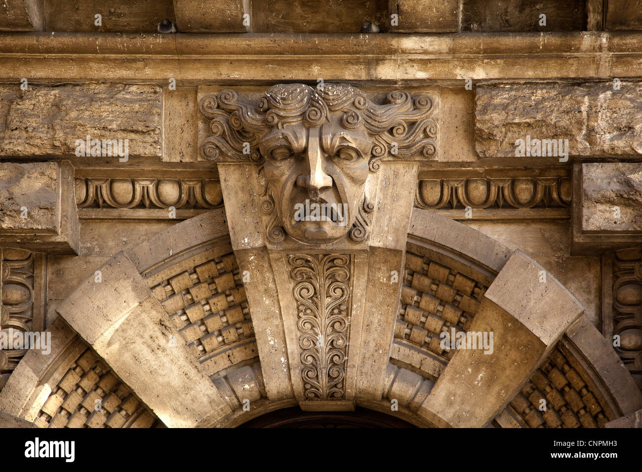Ornately carved stone doorway with gargoyle, Rome Stock Photo