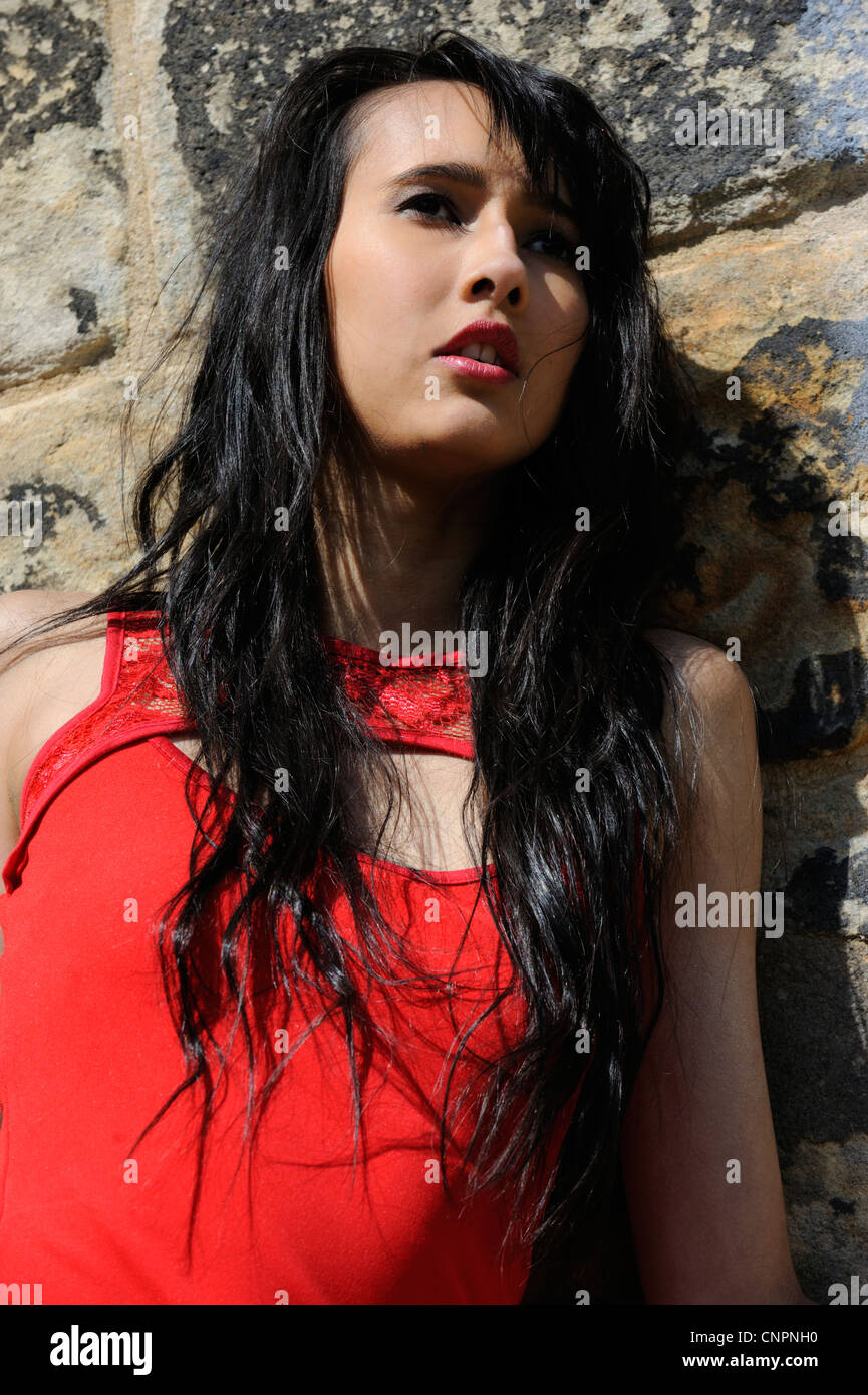 Fashion model 'Kittiwara' in a red Cassie Lace Bodycon Dress by BooHoo Stock Photo