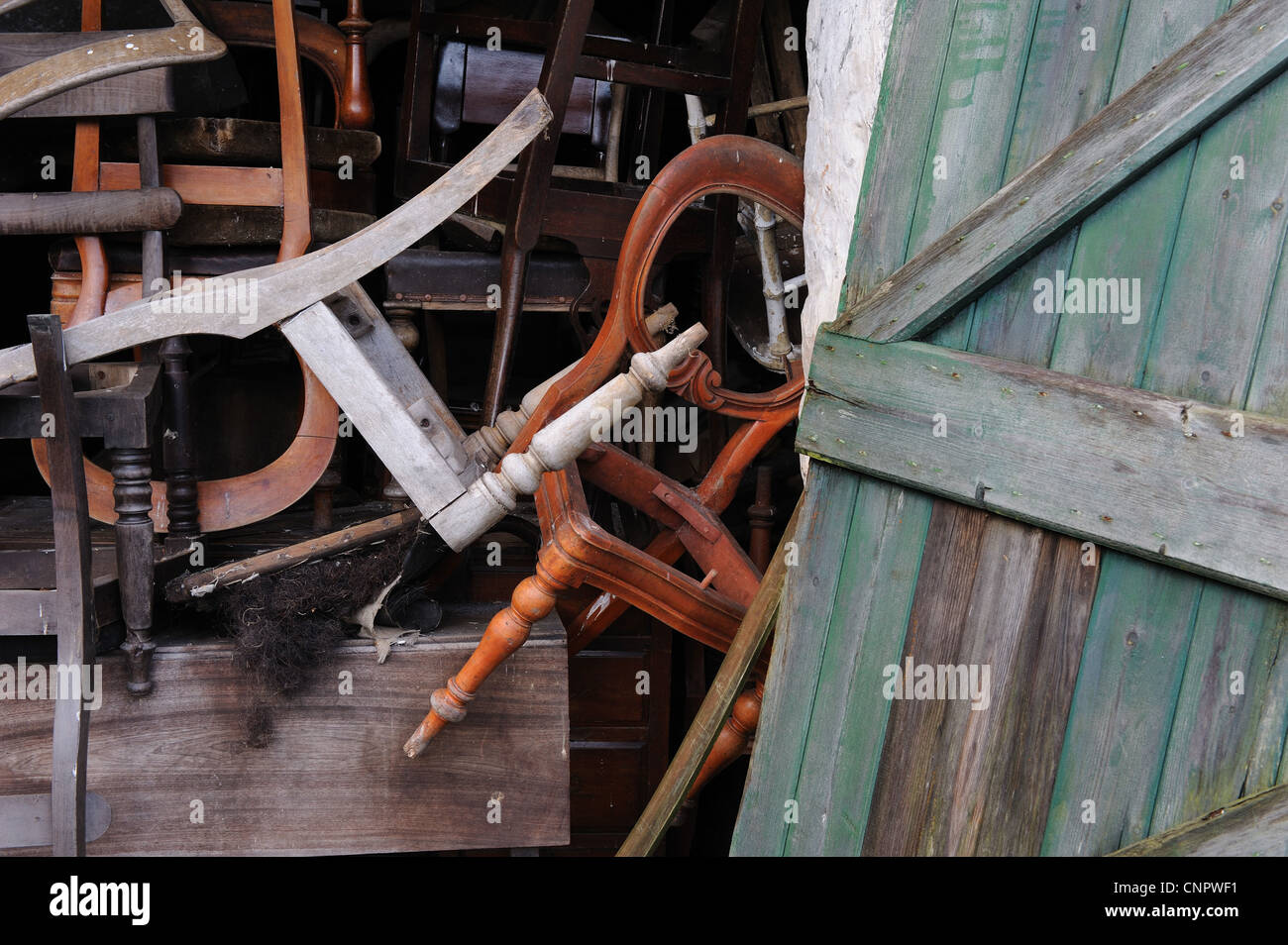 Old wooden dining chairs thrown into a furniture store Stock Photo