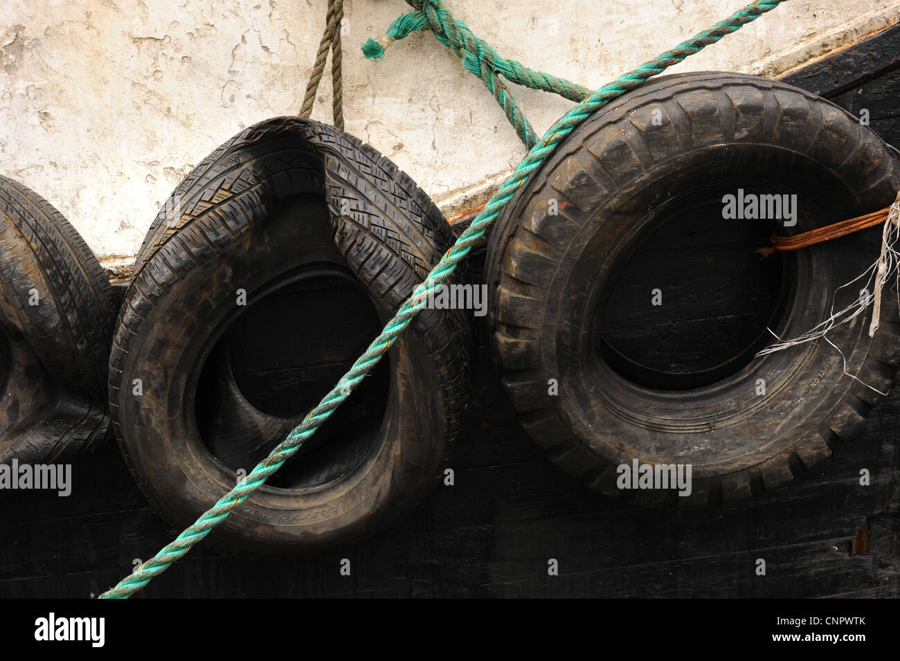 Rubber tyre fenders on an old fishing boat Stock Photo