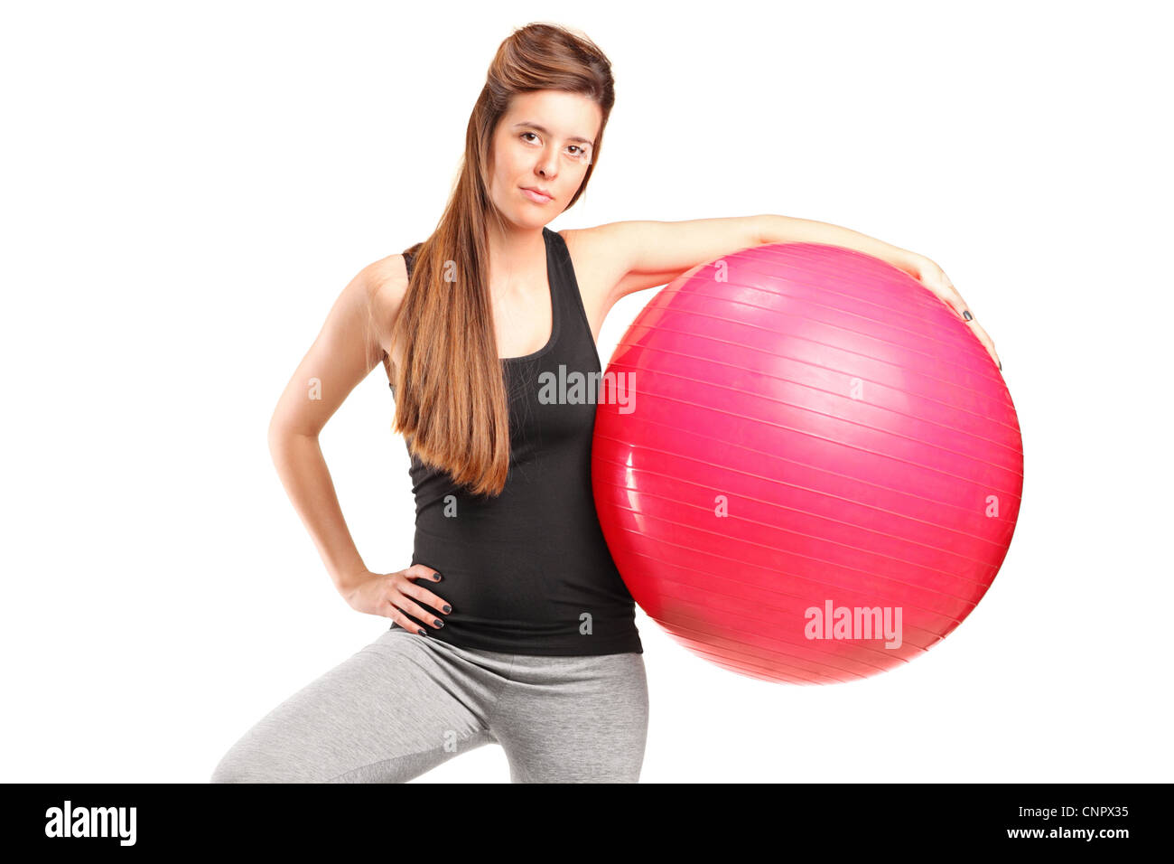 A portrait of a smiling female holding a fitness ball isolated on white ...