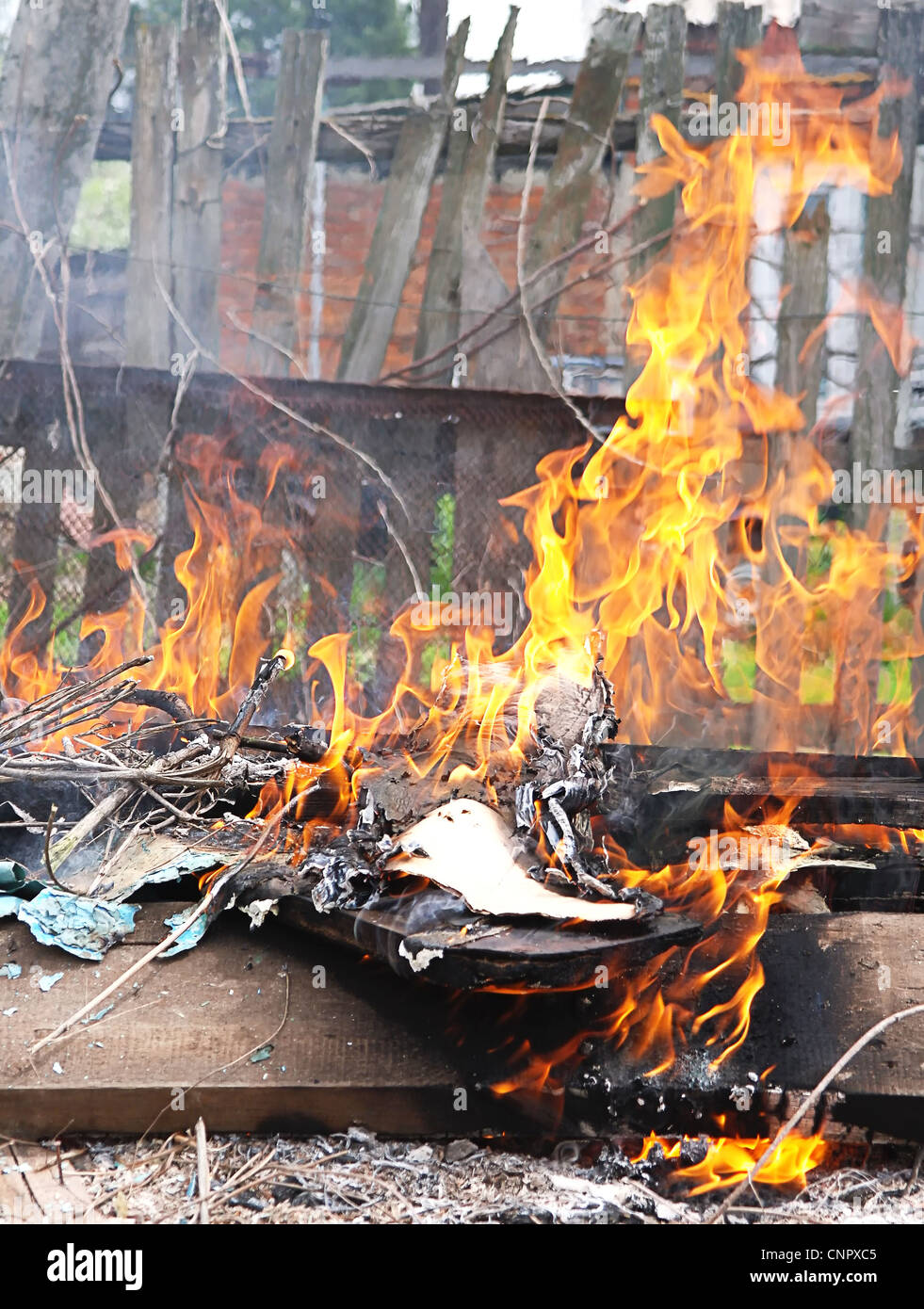 Toxic Fire Flame illegal burn litter in city poison smoke Stock Photo