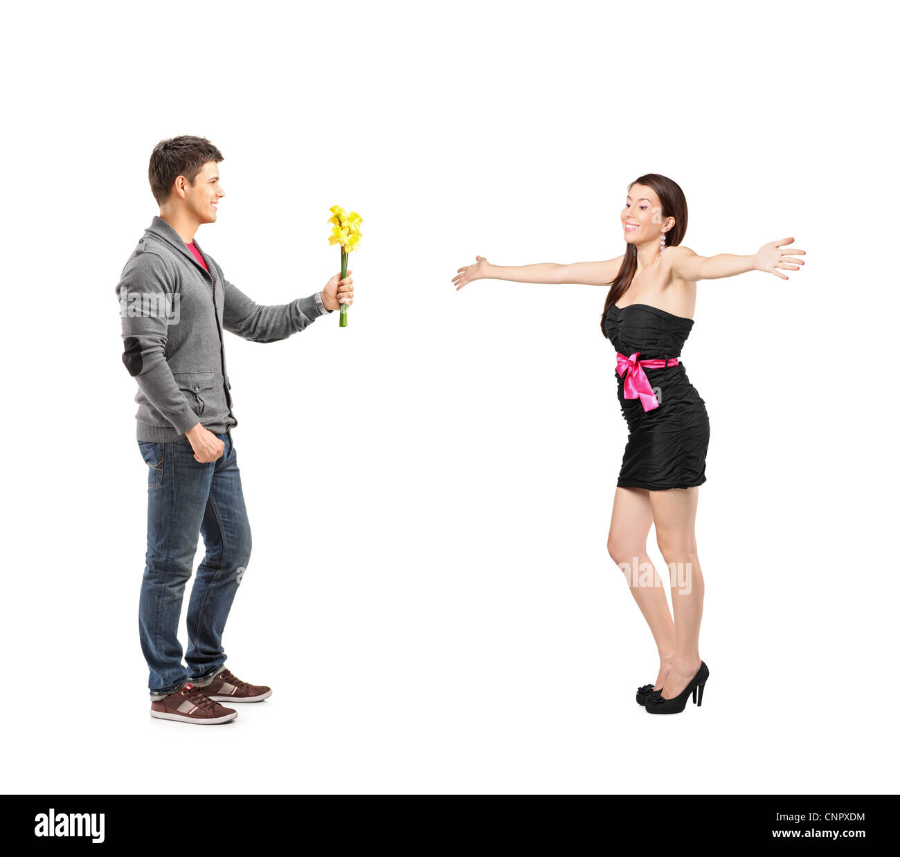 Full length portrait of a boyfriend giving flowers to his excited woman