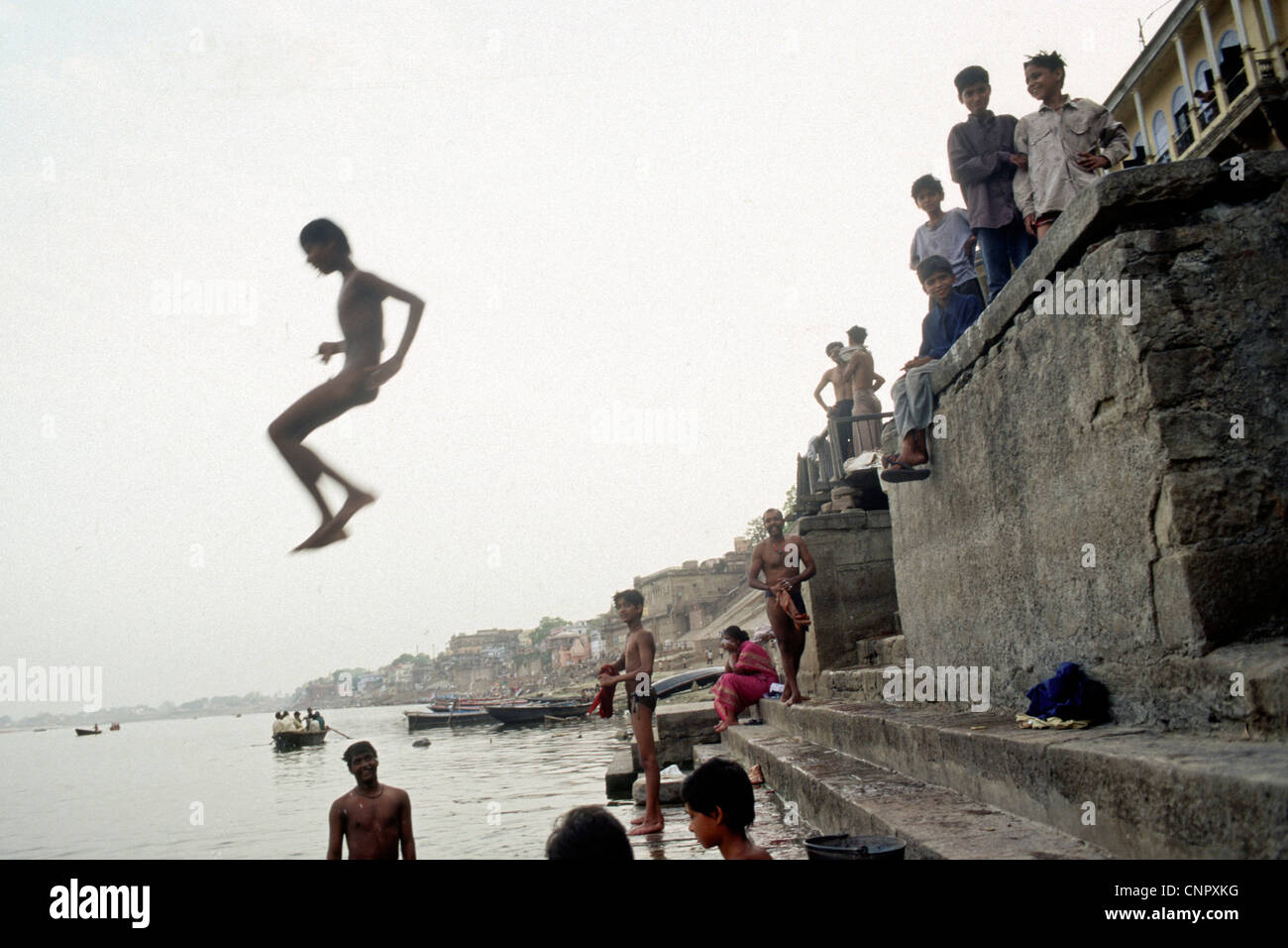 Indian boy jumping on the Ganges river at the ancient Indian city of