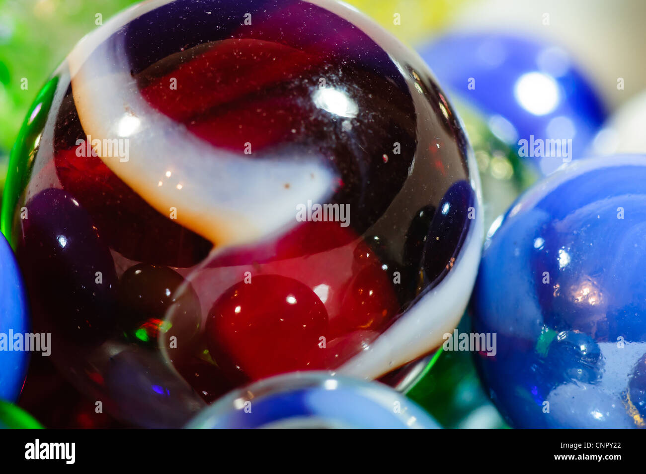 Close up of colored glass marbles reflecting each other Stock Photo