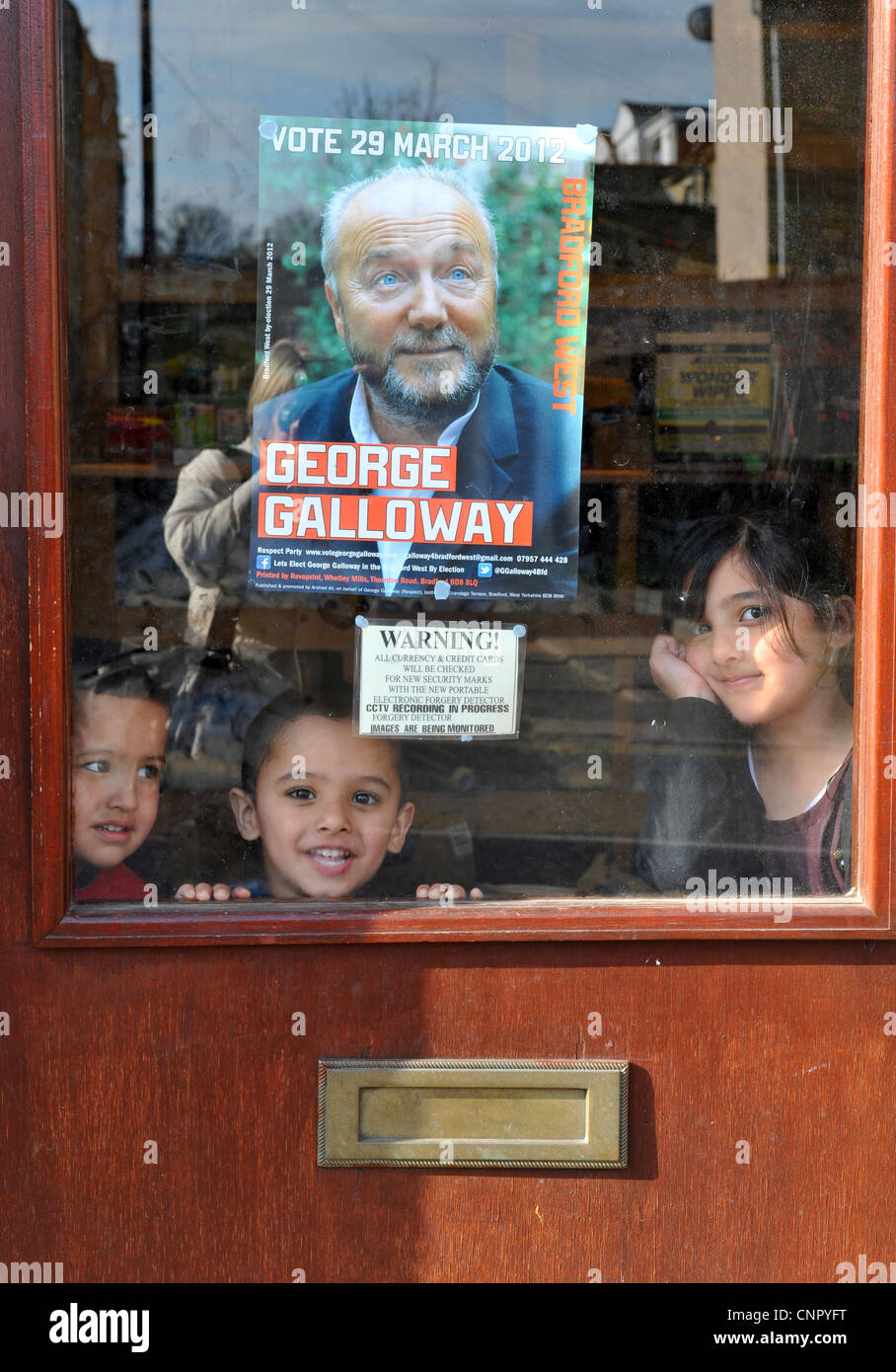 Young Asian children in a shop window in the Bradford West constituency in Bradford, West Yorkshire. Stock Photo