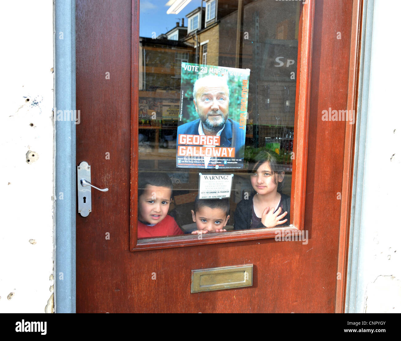 Young Asian children in a shop window in the Bradford West constituency in Bradford, West Yorkshire. Stock Photo