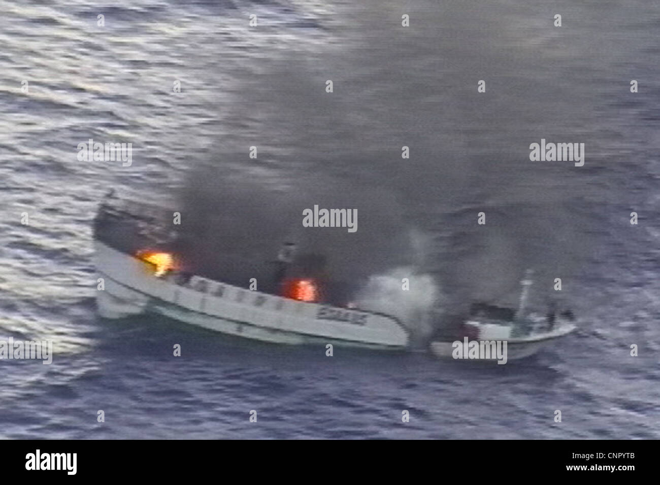 A fire burns uncontrollably aboard the Taiwanese fishing vessel Shin Maan Chun Saturday in the Pacific Ocean. The fire forced the crew of nine to abandon ship and through a coordinated effort between the U.S. 7th Fleet and U.S. Coast Guard District 14, all of the fishermen were safely rescued and brought aboard the Marshallese-flagged bulk carrier Semirio. Stock Photo