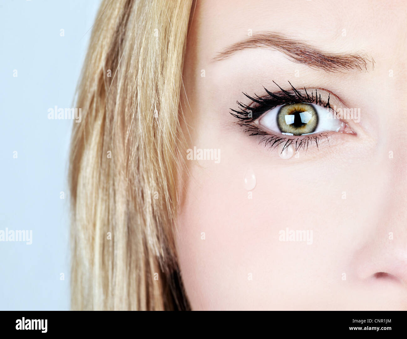 Crying woman, beautiful face with tear drops, facial expression, pain and grief concept Stock