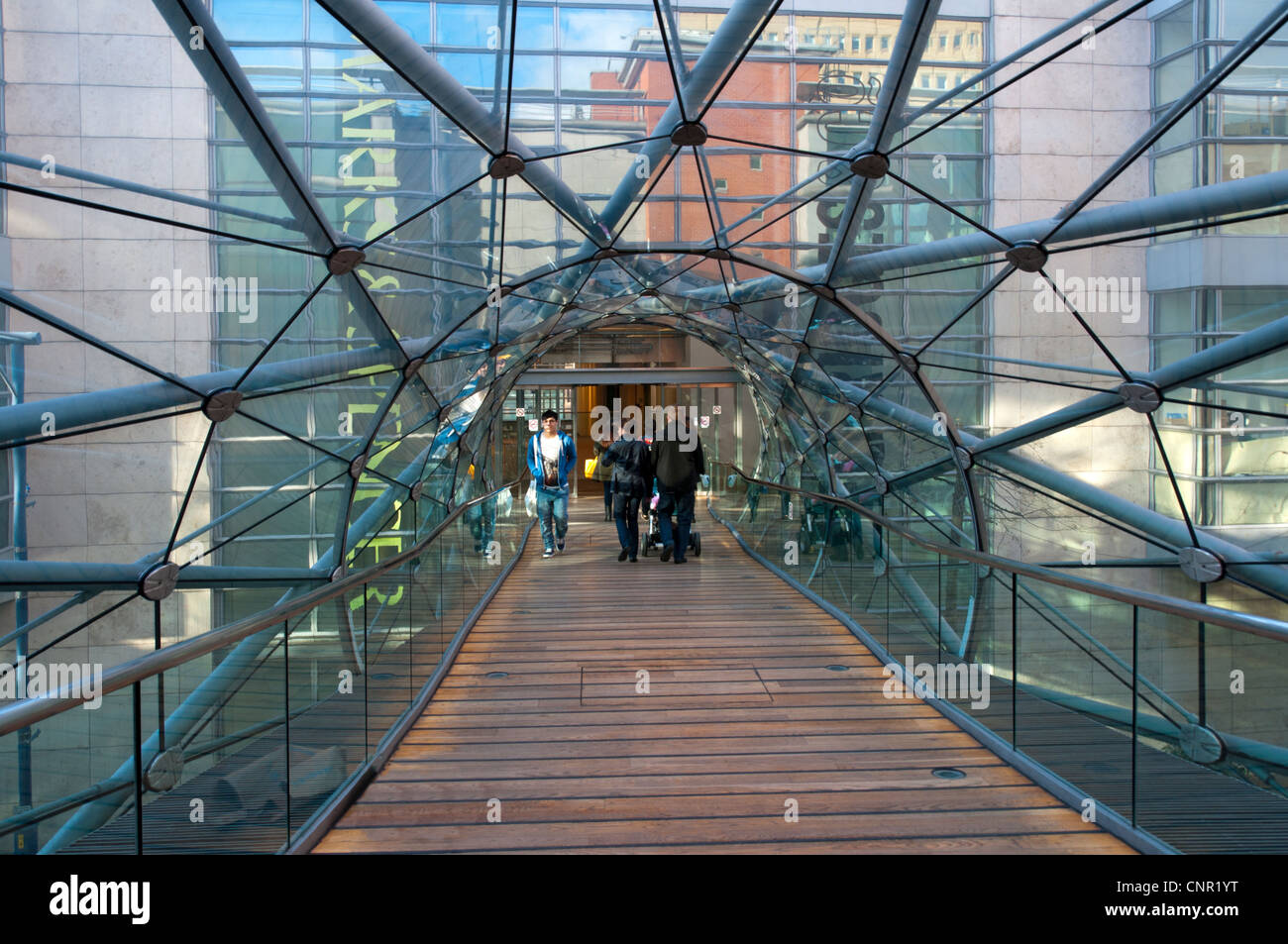 Enclosed footbridge over Corporation Street linking the Arndale Centre to the Marks & Spencer store. Manchester, England, UK Stock Photo