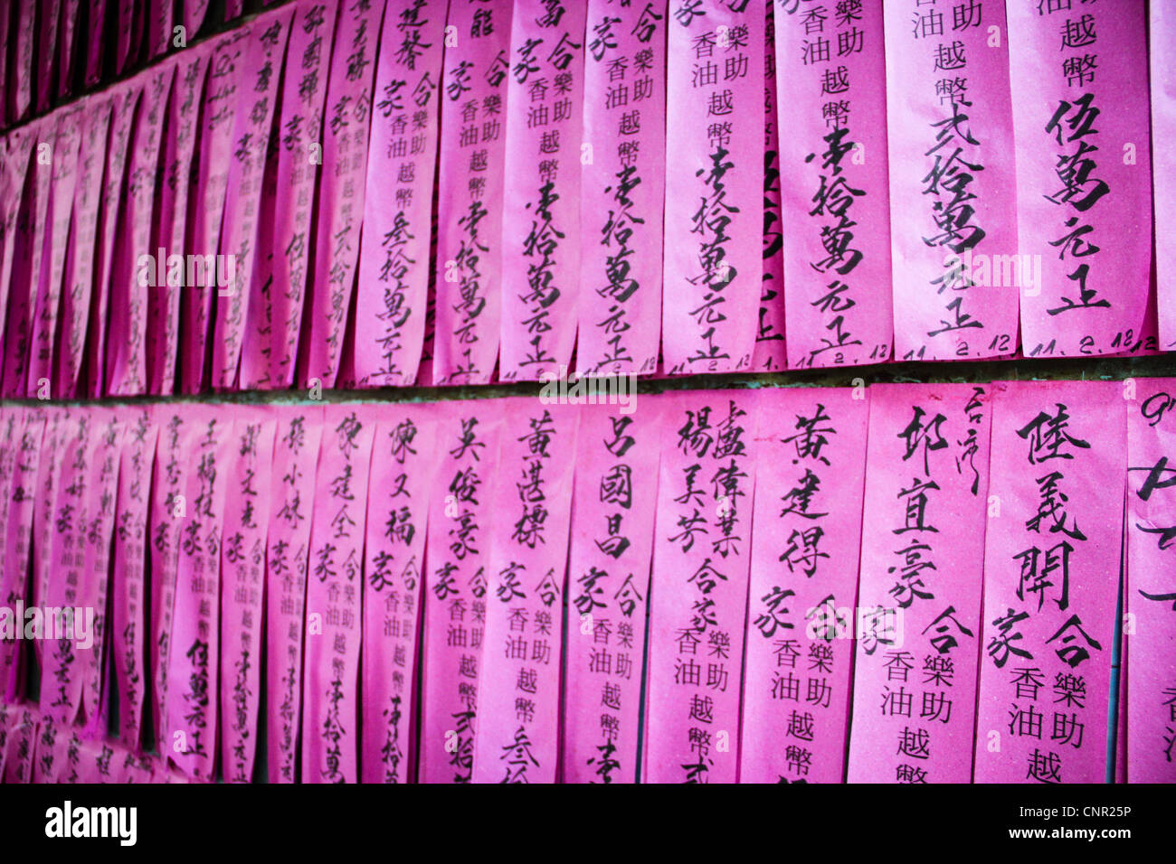 Paper prayers in a Buddhist temple in central Saigon, Vietnam Stock Photo