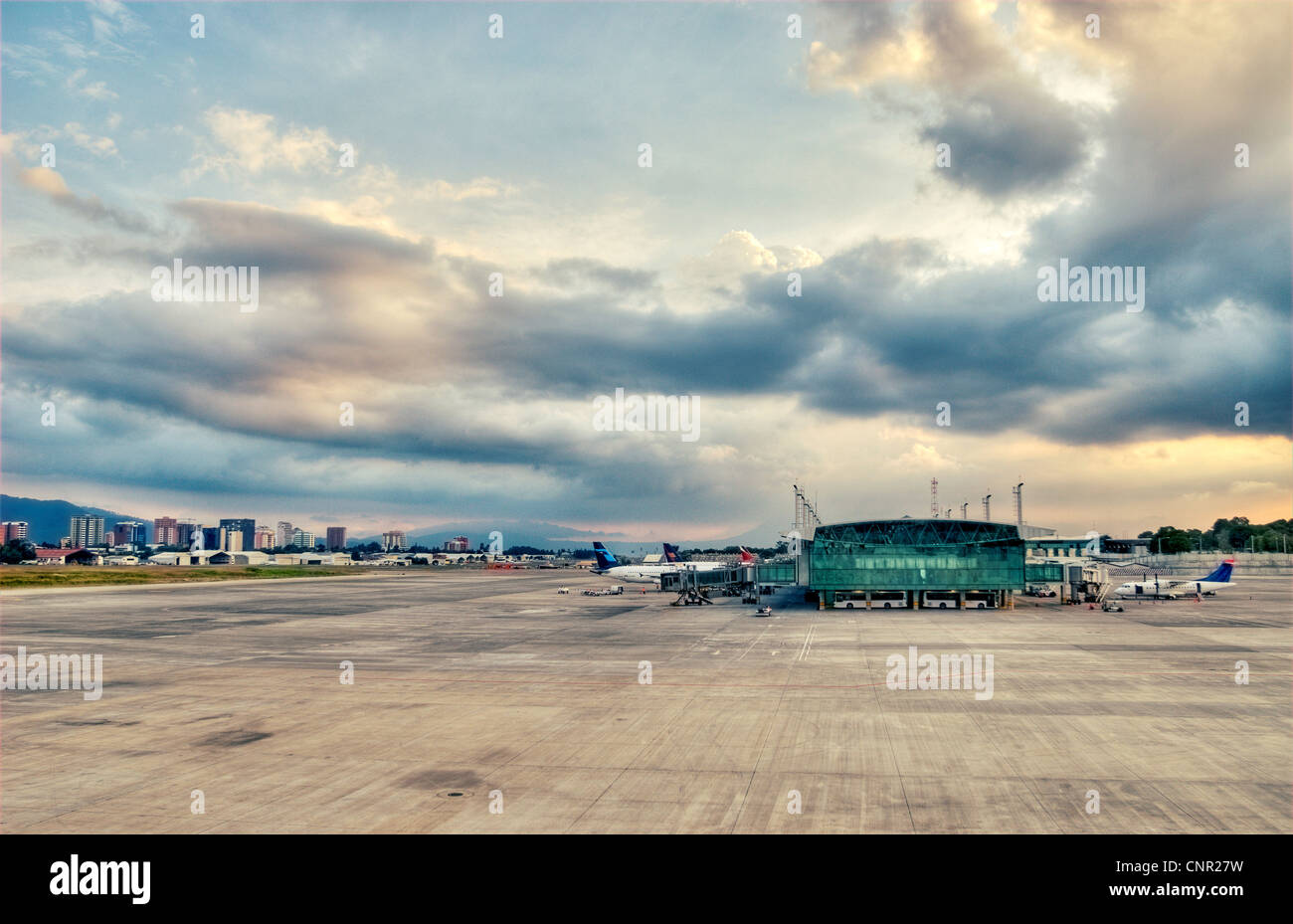 North terminal of Guatemala City's La Aurora International Airport (GUA); to the left is the city's Zona 14 skyline. Stock Photo