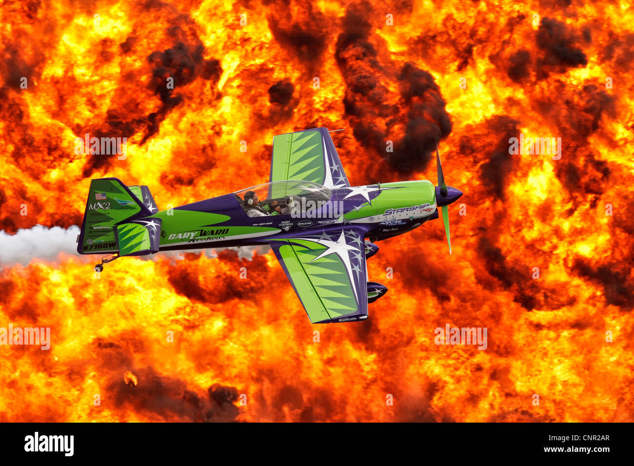 Gary Ward flies his airshows MX2 low against a firewall back drop Stock Photo