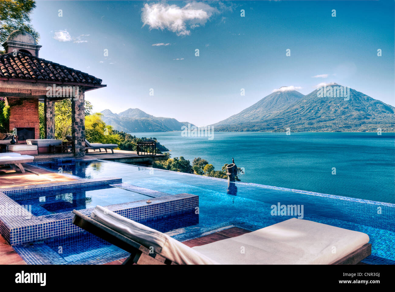 View of Lake Atitlan and Atitlan and Toliman volcanoes from the villa's pool at Casa Palopo. Stock Photo