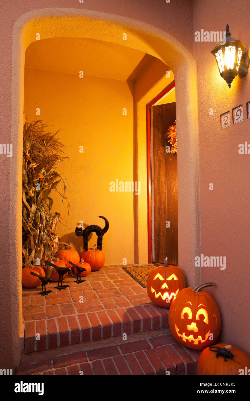 House entryway with Halloween Jack-O-Lantern Pumpkins Stock Photo