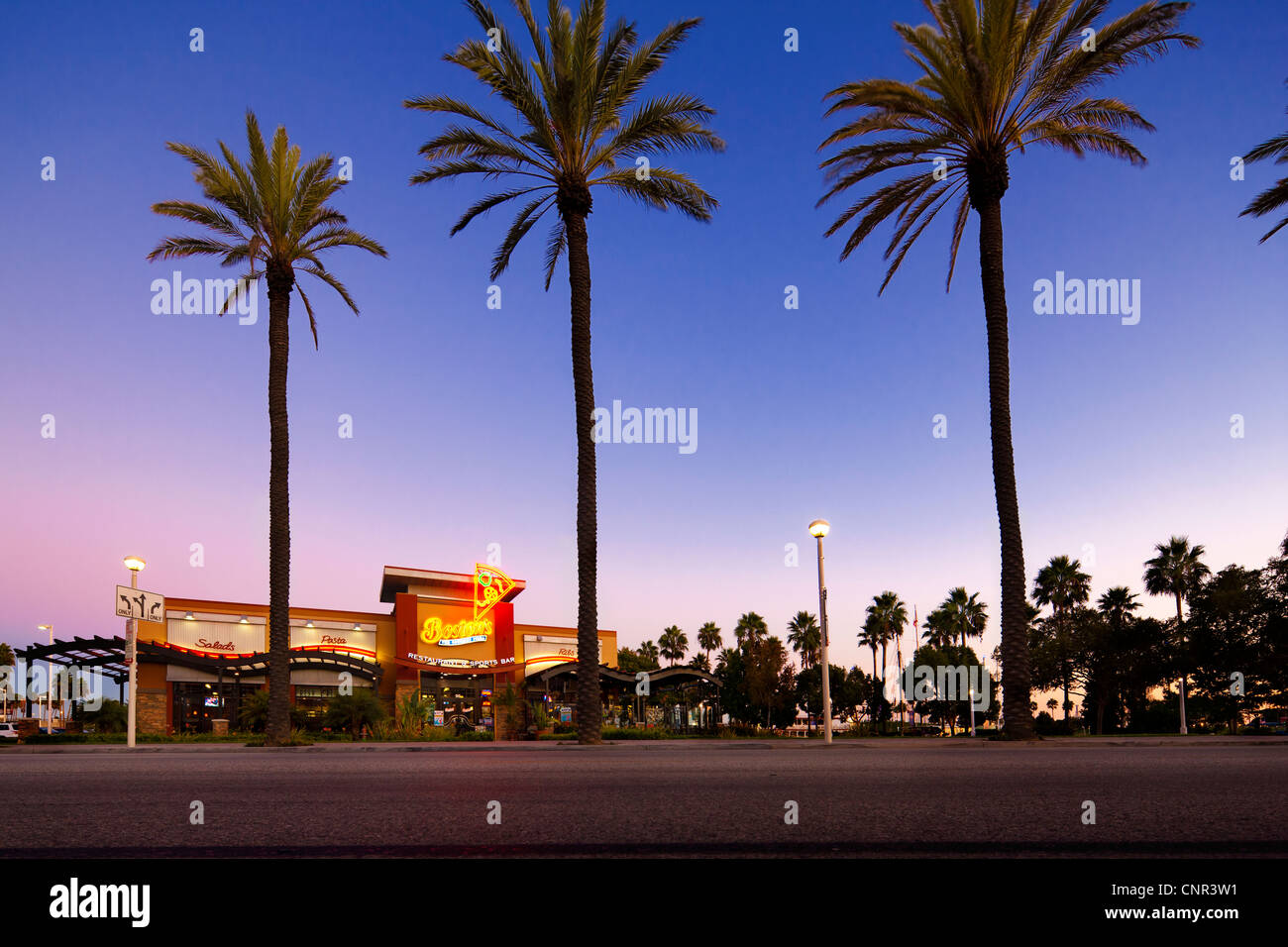 Long Beach California, Gourmet Pizza Restaurant & Sports Bar with palm trees at dusk Stock Photo