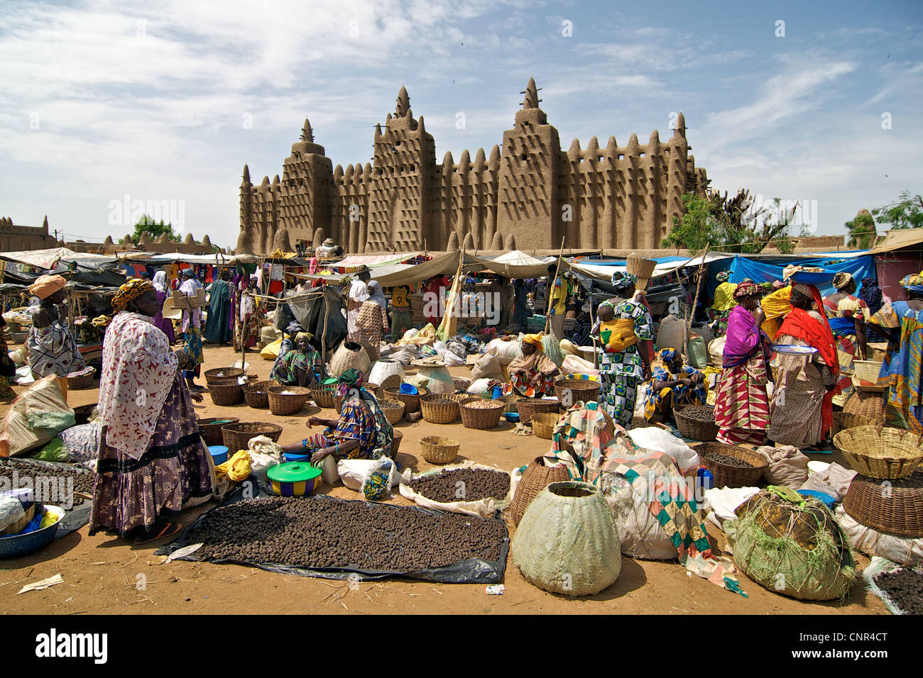 A marketplace in front of the Great Mosque of Djenne in Djenne, Mali. Stock Photo