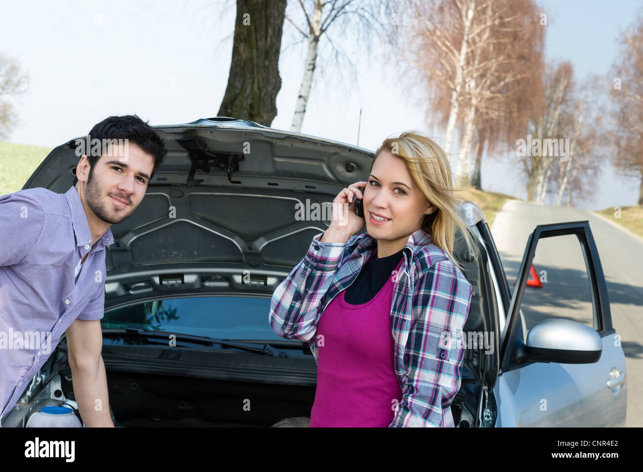 Car breakdown couple calling for road assistance repair motor defect ...