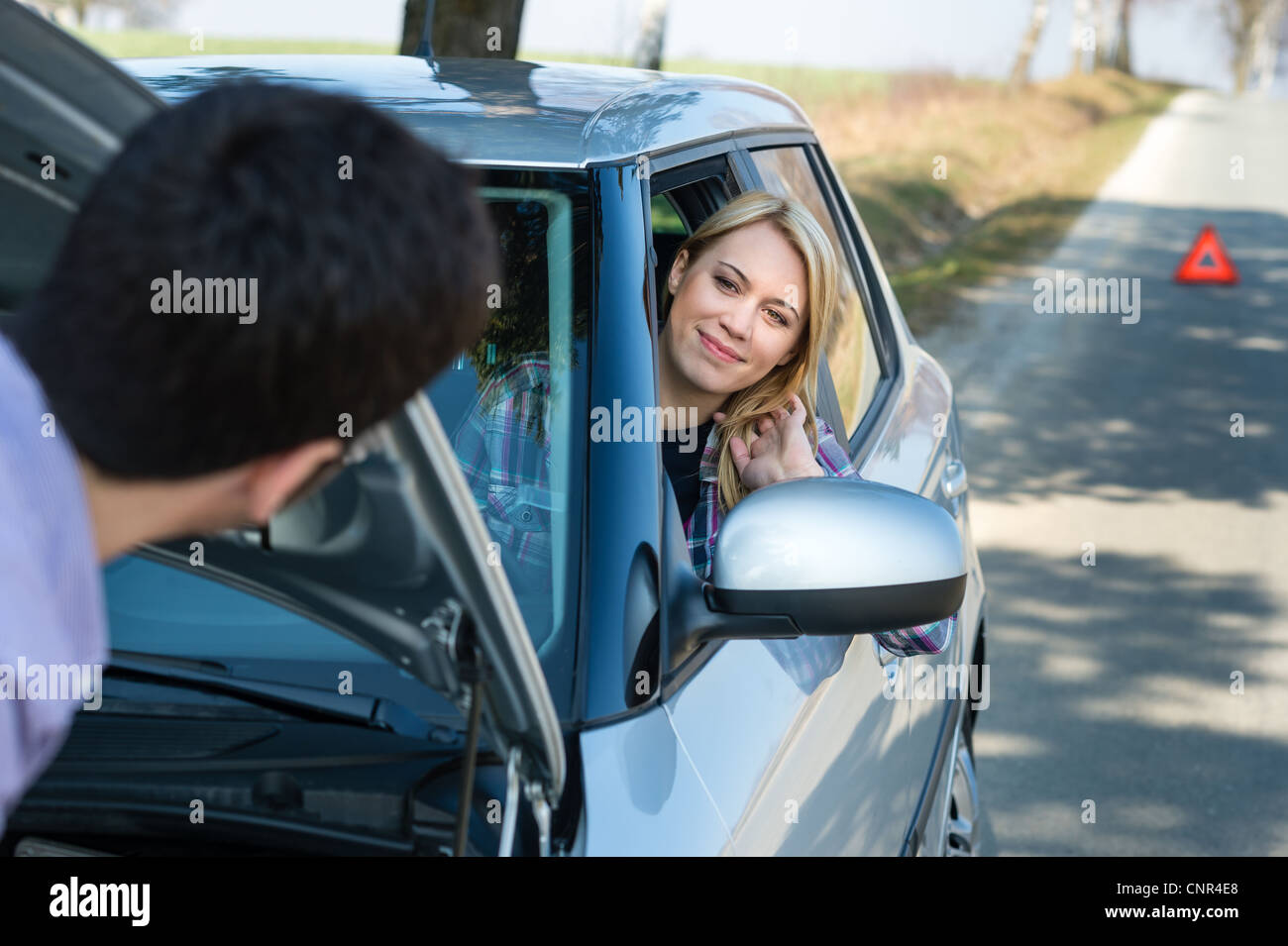 Car troubles man help woman defect vehicle on the road Stock Photo Alamy