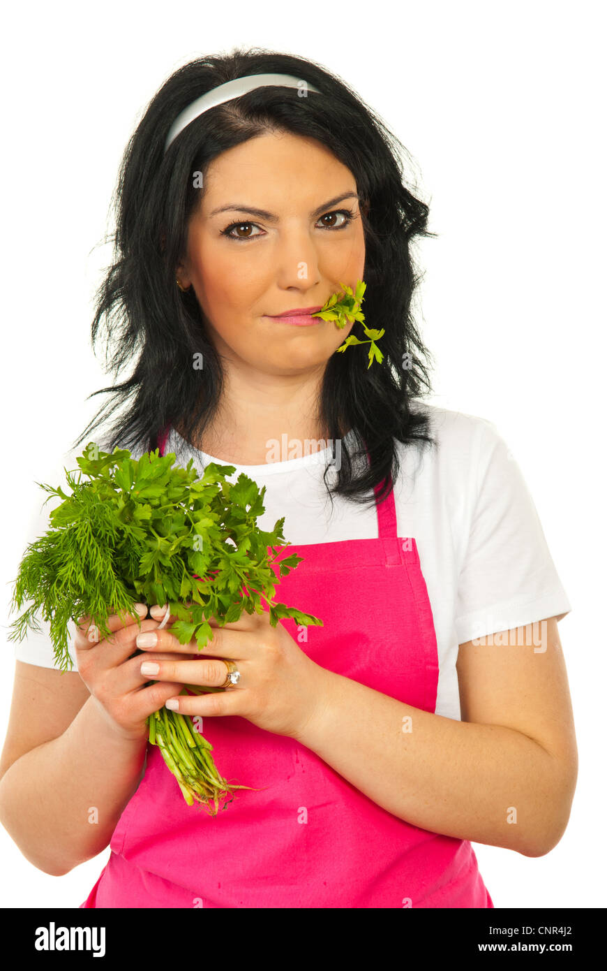 Beauty woman eating parsley and holding fresh bouquet of parsley and